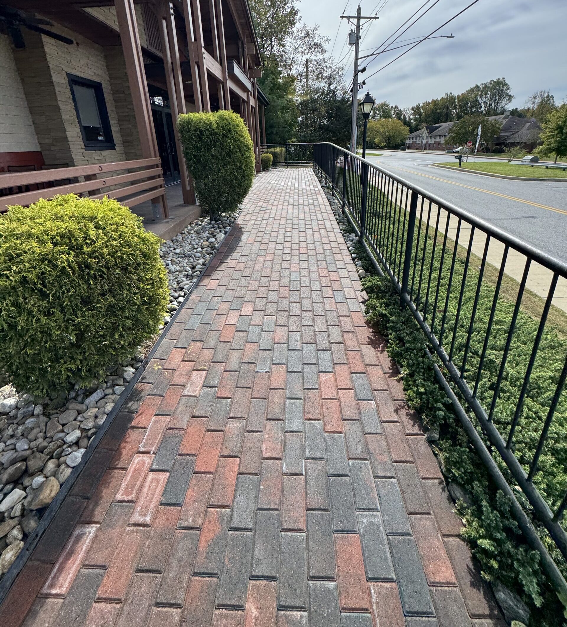 new paver sidewalk for an outback steakhouse restaurant with red and black bricks.