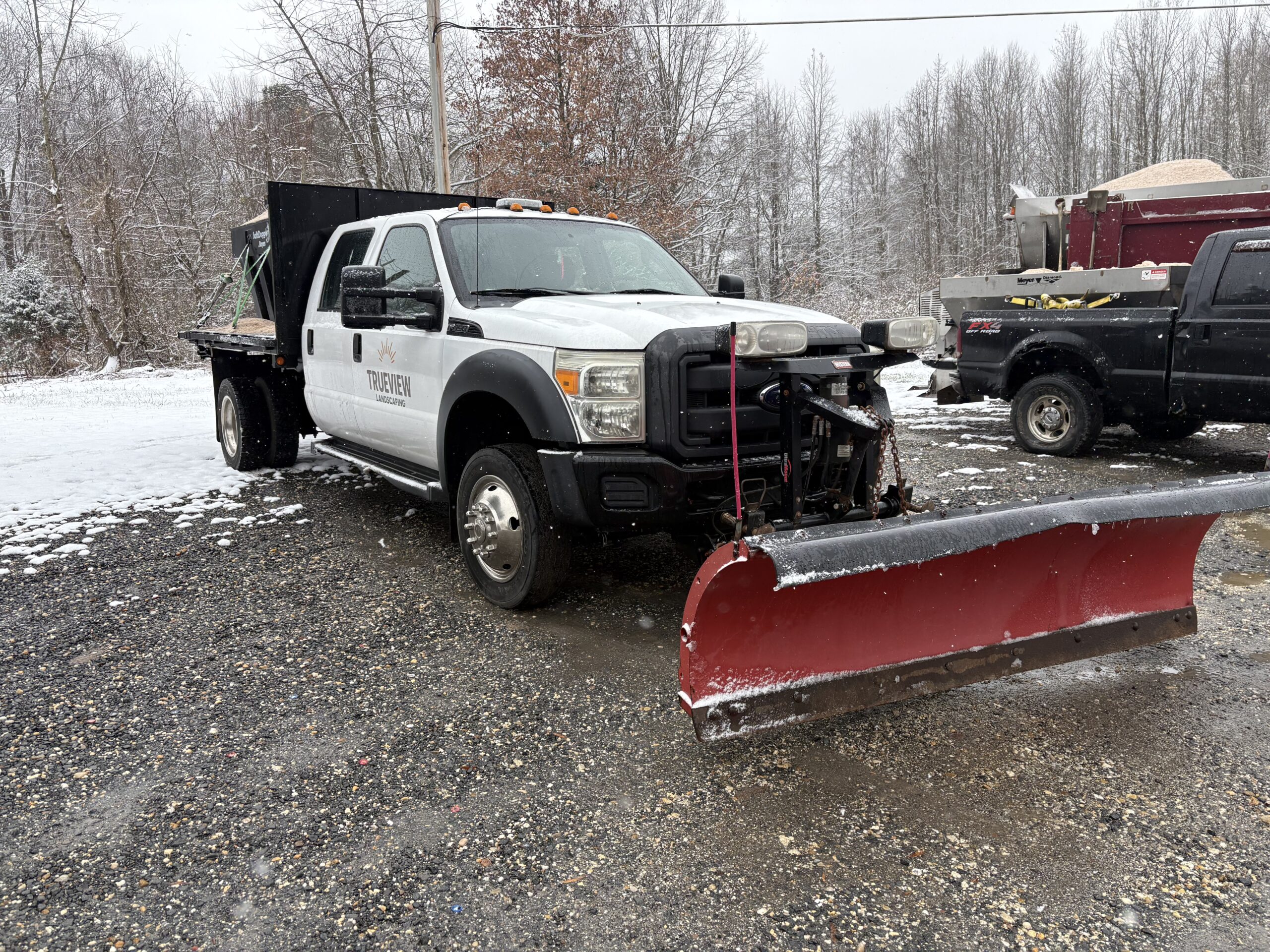 image of snow plowing truck after clearing parking of snow in southern maryland